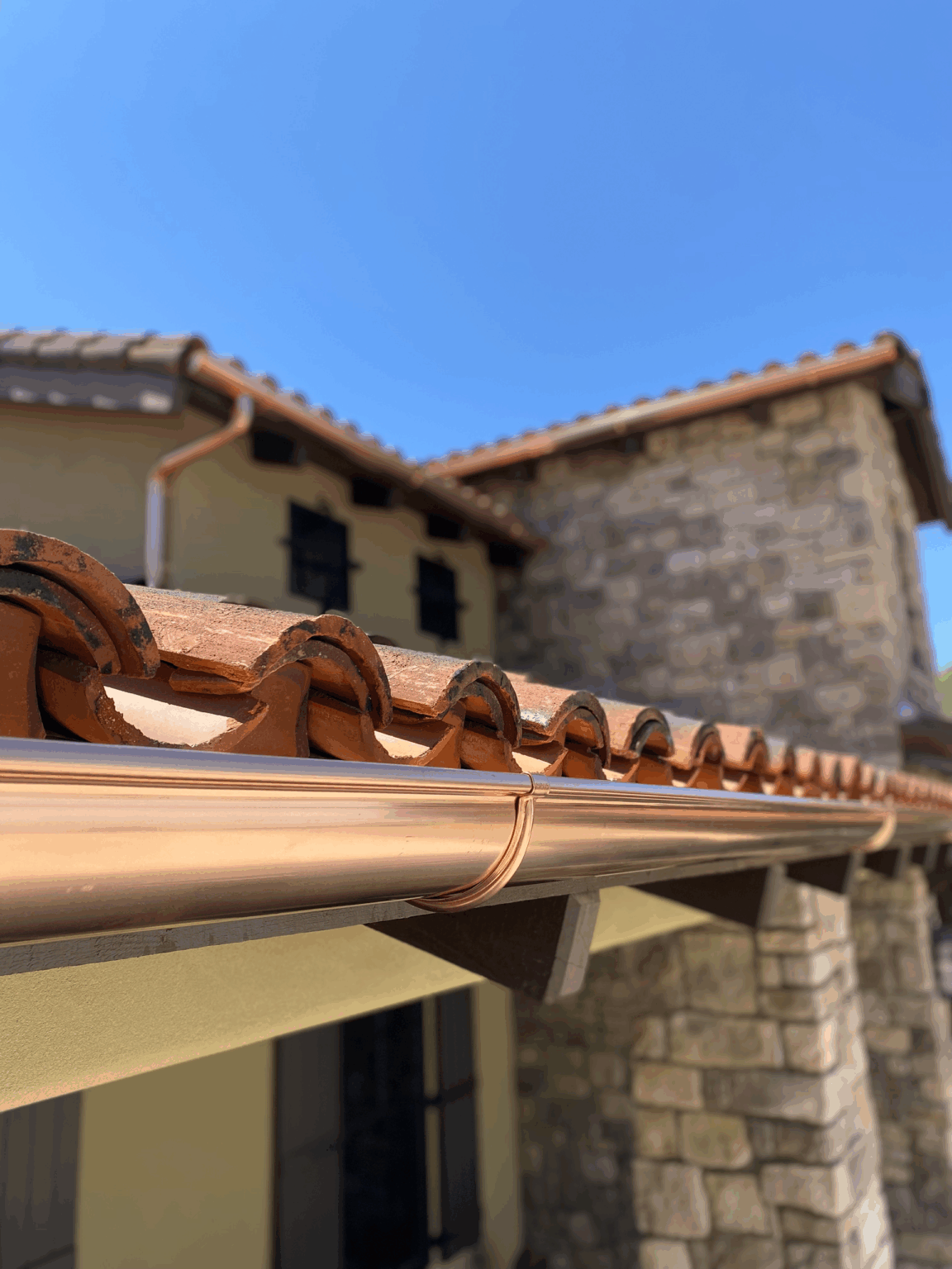 High End Half Round Copper Gutter Installation protecting entry way to home